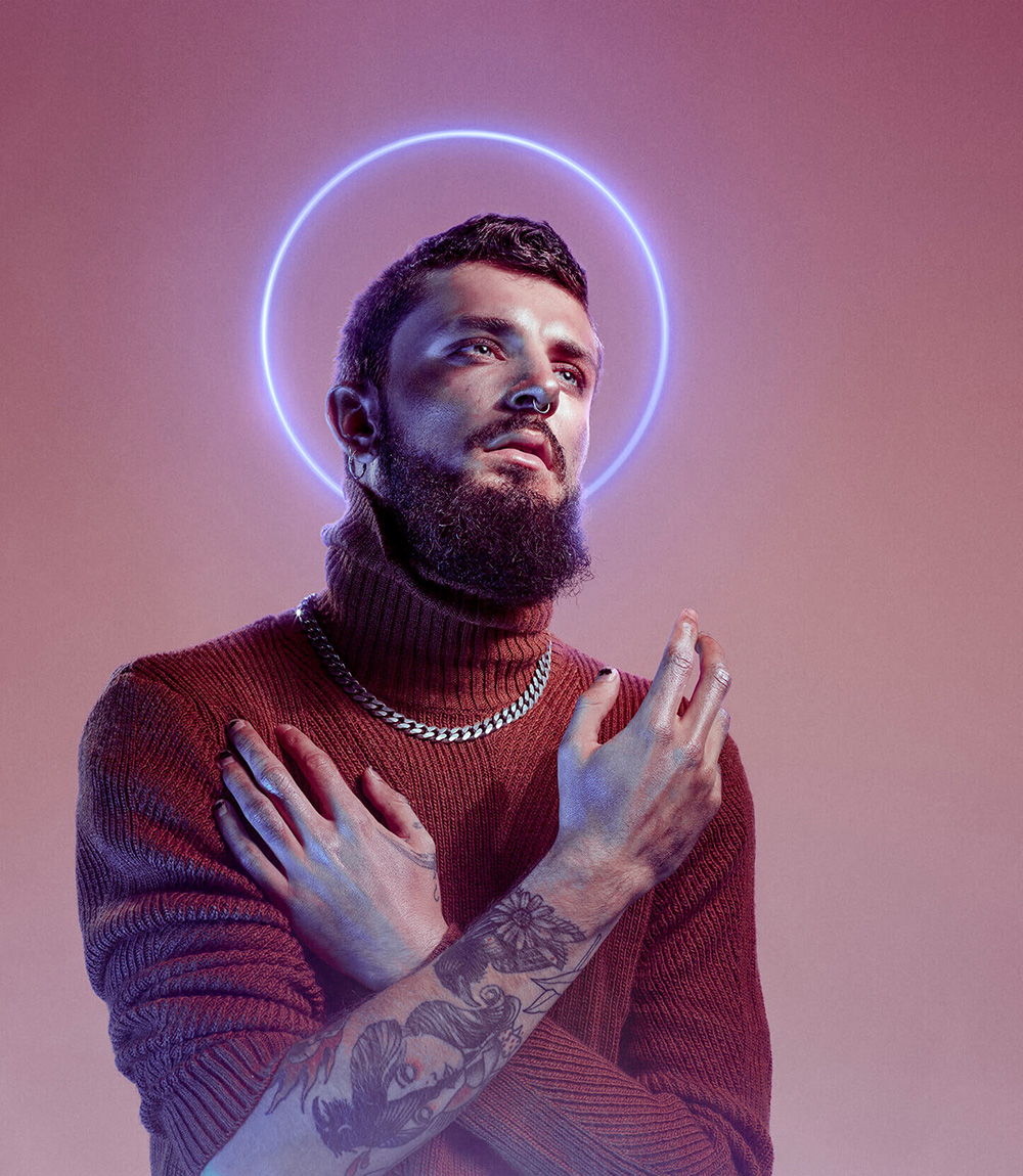 Design Photo of a praying tattooed man with halo over his head